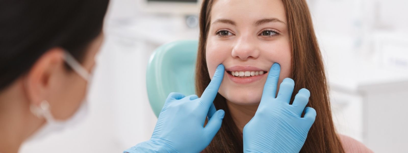 girl creating smile at dentist