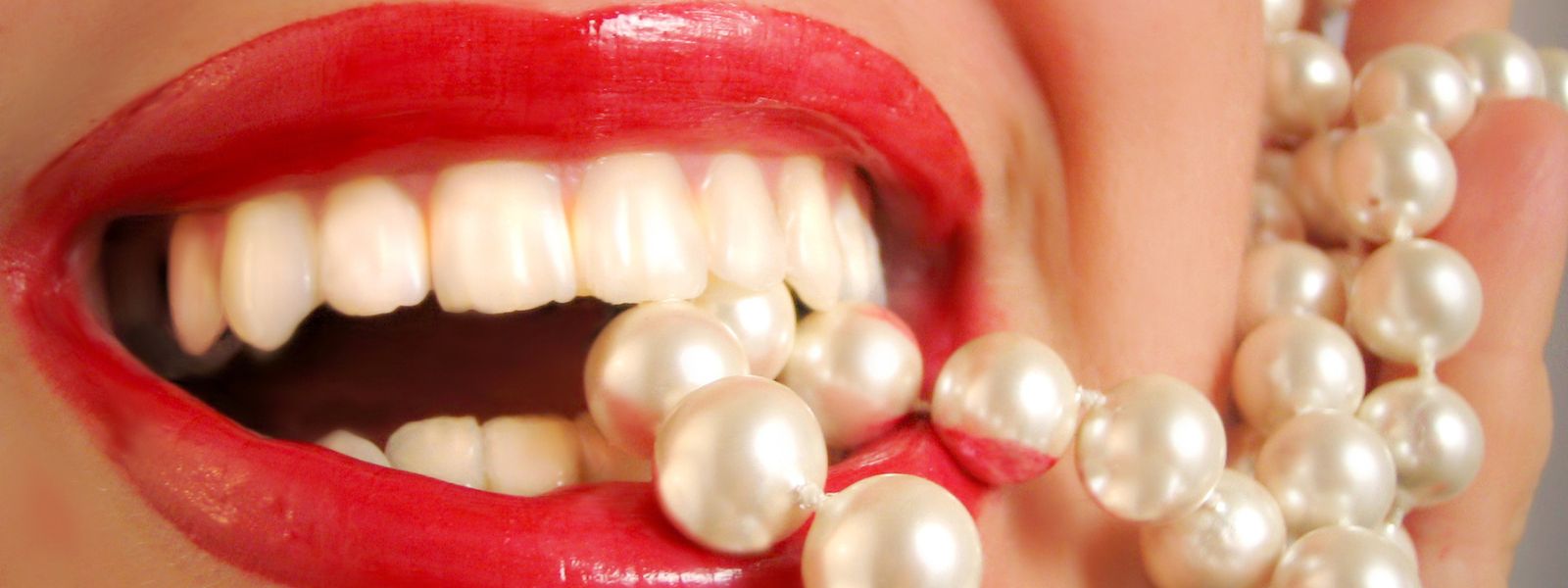 girl biting pearls